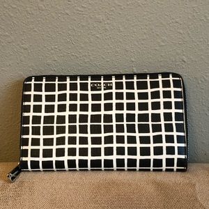 Coach zip wallet with black and off white checkered pattern.